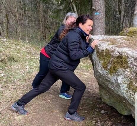To personer prøver å rugge på steinen
