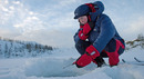 Girl wearing insulating primaloft jacket ice fishing with mormyshka ----Jente med isolerende jakke i primaloft fisker p� isen med mormyshka