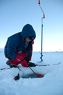 Girl ice fishing a cold december day----Jente fisker p� isen en kald ettermiddag i desember